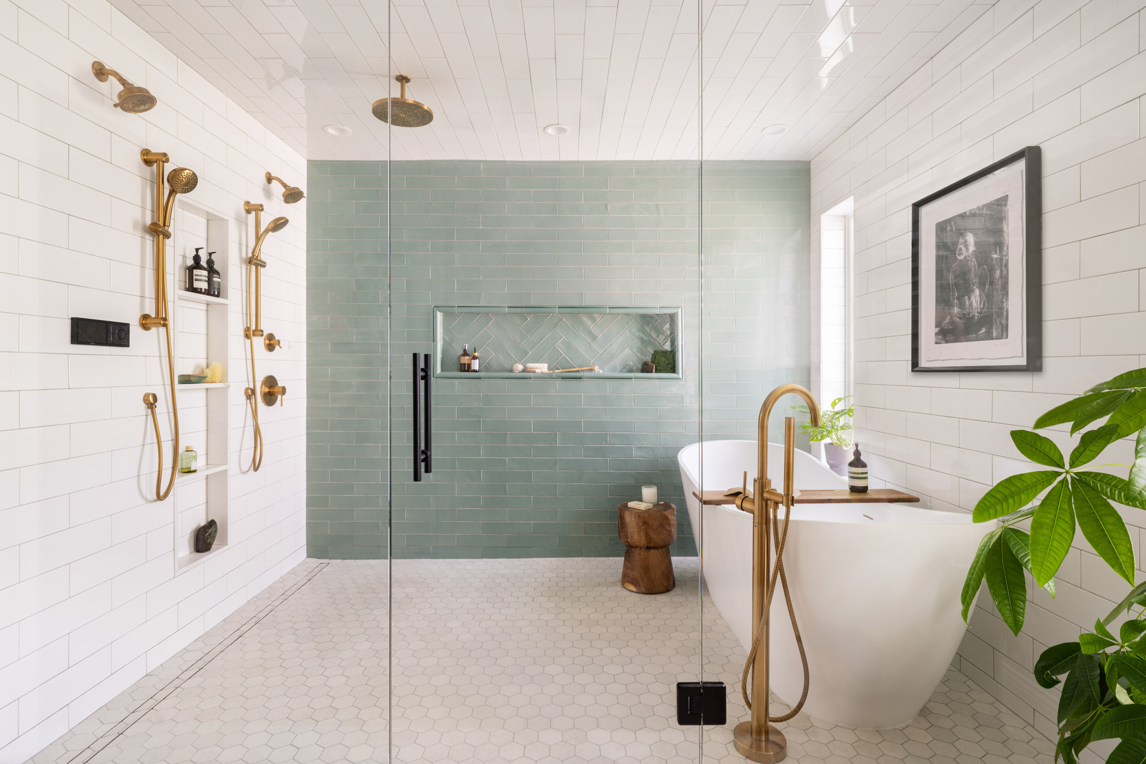 Spa-like master bathroom with dual brass showerheads, freestanding tub, and green tile feature wall