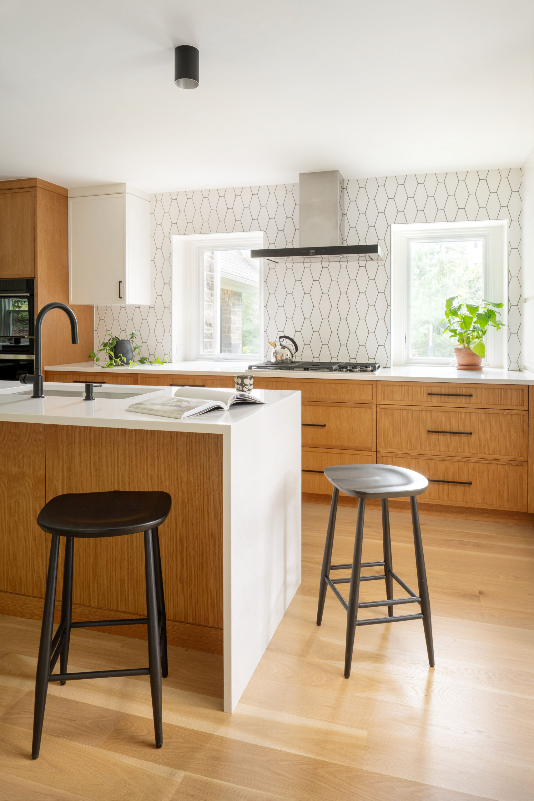Contemporary kitchen featuring white quartz island and oak cabinetry